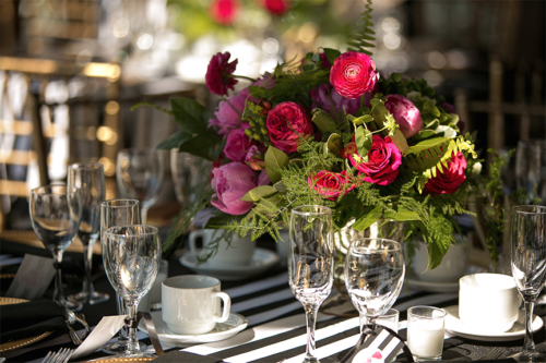 black and white striped linens, pink ranunculus